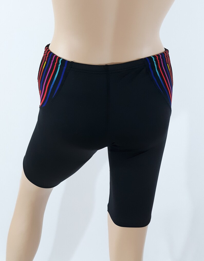 May include: Black swim shorts with a colorful striped design on the sides.
