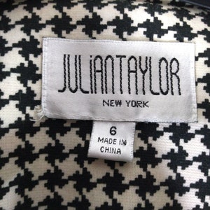 May include: White and black houndstooth fabric with a white tag that says "JULIAN TAYLOR NEW YORK" and a smaller white tag that says "6 MADE IN CHINA"