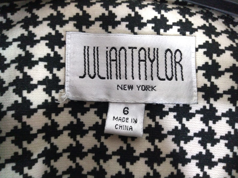 May include: White and black houndstooth fabric with a white tag that says "JULIAN TAYLOR NEW YORK" and a smaller white tag that says "6 MADE IN CHINA"