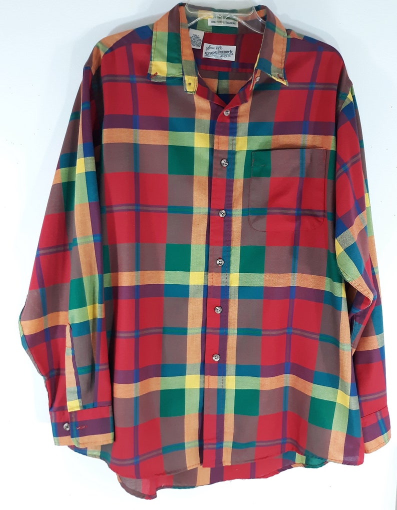 May include: A long-sleeved plaid shirt in red, green, yellow, and blue. The shirt has a button-down collar and a single chest pocket. The label reads "J.G. Hook" and "Scranton, PA".