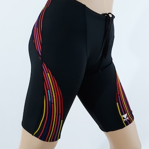 May include: Black swim shorts with a colorful stripe design on the side. The shorts have a drawstring waist and a small logo on the right leg.