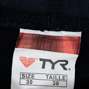 May include: A white TYR brand tag with a red logo and the text "SIZE 30" and "TAILLE 30".