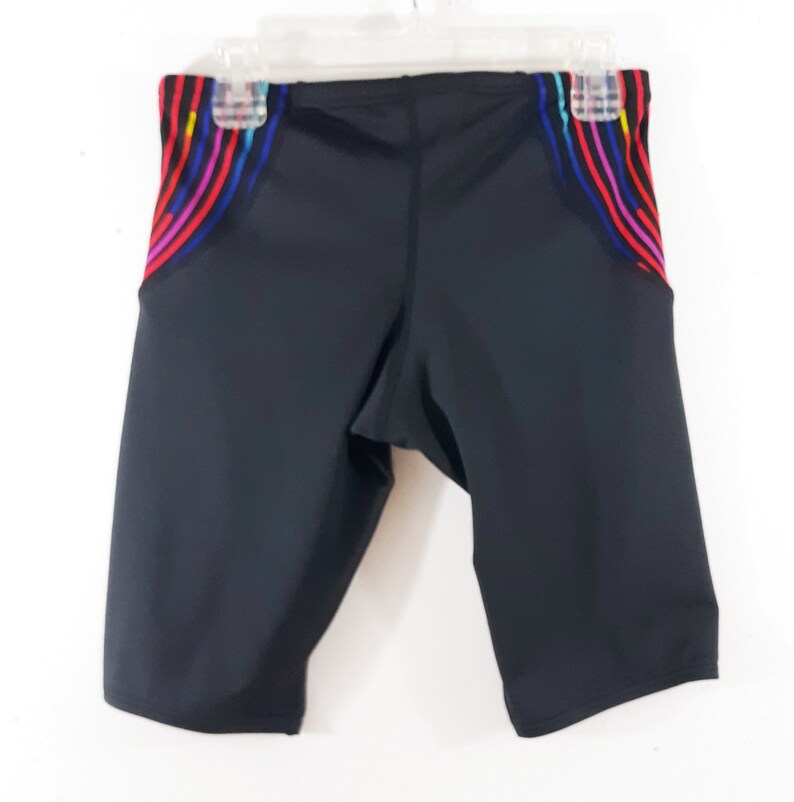 May include: Black swim trunks with colorful striped accents on the sides.