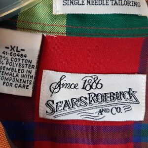May include: A red, green, yellow, and blue plaid shirt with a white tag that says "XL" and "Since 1886 Sears Roebuck and Co."