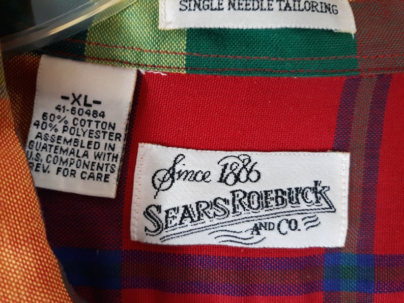 May include: A red, green, yellow, and blue plaid shirt with a white tag that says "XL" and "Since 1886 Sears Roebuck and Co."