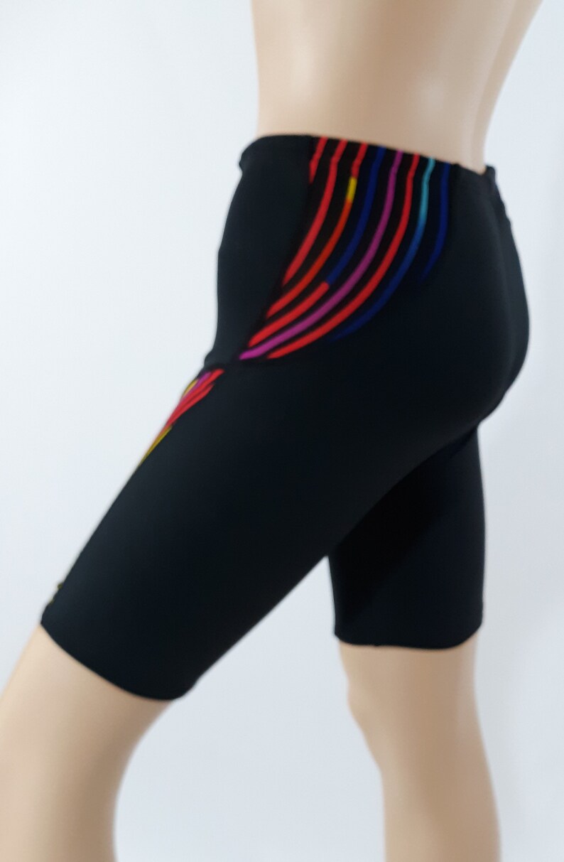 May include: Black athletic shorts with colorful stripes on the side.