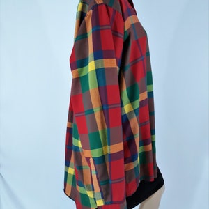 May include: A long-sleeved button-down shirt with a multi-colored plaid pattern. The shirt features red, green, yellow, and brown plaid squares.
