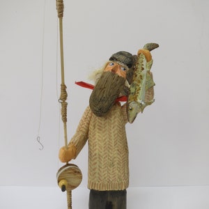 Unique, handmade, rustic, nautical sculpture of a fisherman with fishing rod and his catchl made from recycled North Sea driftwood.
