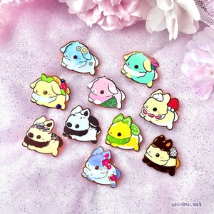 May include: Set of ten enamel pins featuring cute cartoon bunnies in various pastel colors and designs. Each bunny is holding a different type of dessert, such as a strawberry shortcake, a lemon meringue pie, and a chocolate cake.