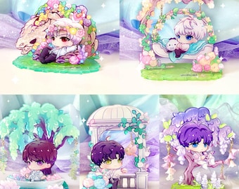May include: A collection of acrylic anime-style figures. Each figure features a chibi character in a fantasy setting, such as a swing, boat, or with a dragon. The figures are in various pastel colors with floral and nature-themed elements.