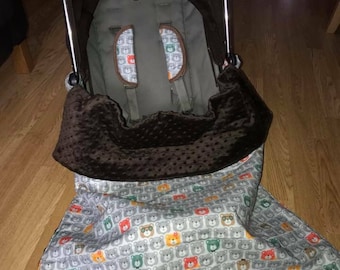 Slightly padded blanket with straps to attach to pram frame n safety belts pads bears