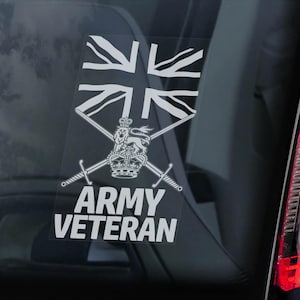May include: A white decal featuring the Union Jack flag, crossed swords, a crown, and the text "ARMY VETERAN." The decal is affixed to a vehicle window, with a red taillight visible on the right.
