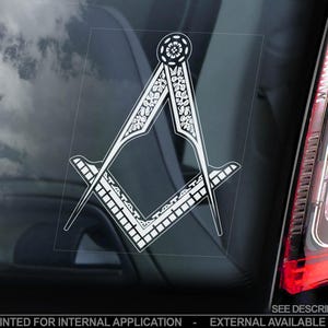 May include: A white vinyl sticker of a Masonic compass and square with intricate floral designs. The sticker is printed in reverse for internal application and is available in various sizes.