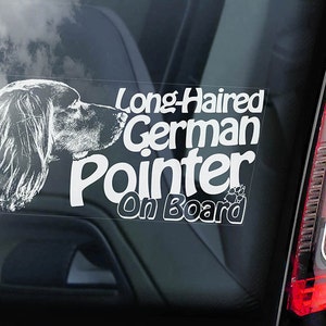 May include: White car window sticker with a black and white illustration of a German Shorthaired Pointer dog's head. The text reads "Long-Haired German Pointer On Board" with paw prints.