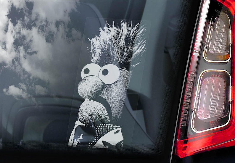 May include: A black and white sticker of a Muppet character with a large nose and big eyes. The character is wearing a suit and has a messy hairstyle.