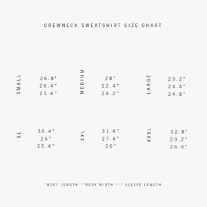 May include: Crewneck sweatshirt size chart with measurements in inches for sizes small, medium, large, XL, XXL, and XXXL.  The chart shows body length, body width, and sleeve length.
