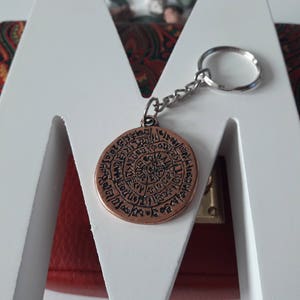 Disco de Festos, disco de Creta, colgante con símbolo de letra, símbolo de Grecia, llavero con disco de Festos, llavero con disco de letra de doble cara.
