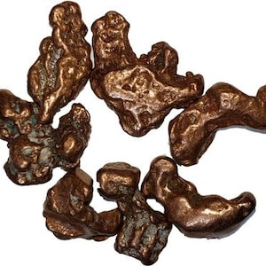 May include: A collection of copper nuggets, each with a unique shape and texture. The nuggets are a rich, reddish-brown color and have a metallic sheen.