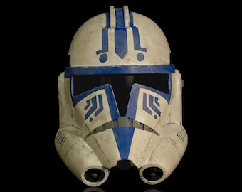 May include: A white and blue plastic helmet with a blue visor and a blue and white design. The helmet has a weathered look.