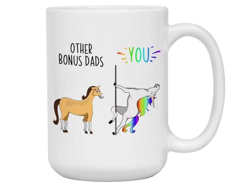 May include: White ceramic mug with a humorous design. The mug features the text "OTHER BONUS DADS" and "YOU" in rainbow colors, along with cartoon illustrations of a horse and a unicorn. The unicorn is pole dancing.