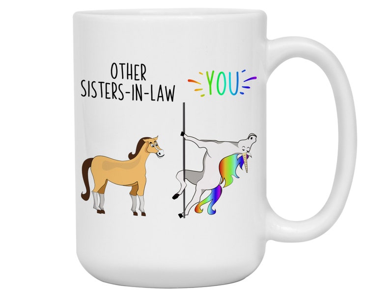 May include: White ceramic mug with a humorous illustration comparing other sisters-in-law to a horse and the best sister-in-law to a unicorn. The text reads "Other Sisters-in-Law" and "You!"