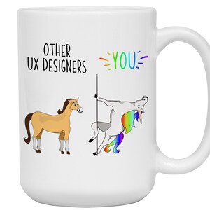 May include: White ceramic mug with a humorous design. The mug features a cartoon illustration comparing "Other UX Designers" to a horse and "YOU" to a unicorn, with rainbow accents. The mug has a large handle.