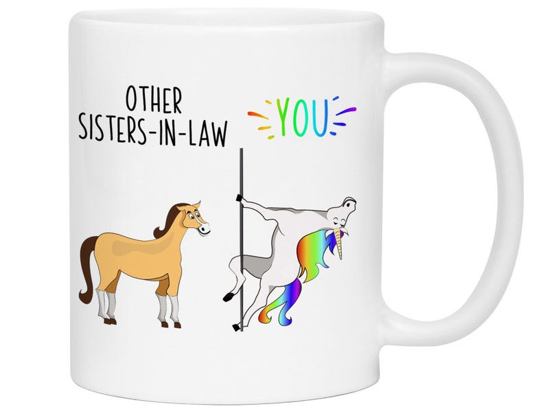 May include: White ceramic mug with a humorous illustration of a unicorn and a horse. The text reads "Other Sisters-in-Law" and "You".
