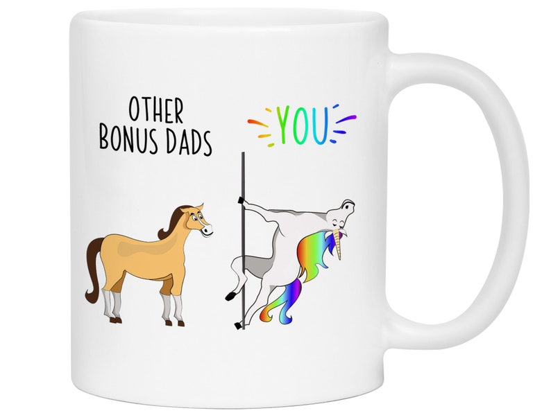 May include: White ceramic mug with a humorous design. The mug features the text "OTHER BONUS DADS" and "YOU" with a rainbow accent. The design includes a cartoon horse and a unicorn pole dancing.
