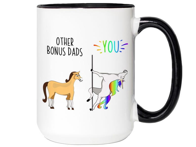 May include: White ceramic mug with a black handle and rim. The mug features a humorous design with the text "OTHER BONUS DADS" and "YOU" in rainbow colors. Illustrations of a horse and a unicorn are also present.