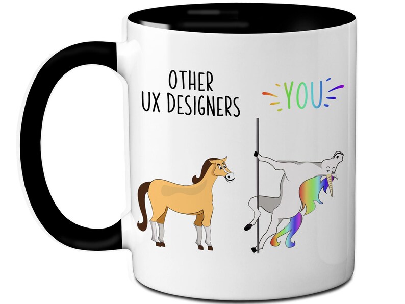 May include: White ceramic mug with a black handle and interior. The mug features a humorous illustration comparing "Other UX Designers" to a horse and "YOU" to a unicorn, with text in black and rainbow colors.