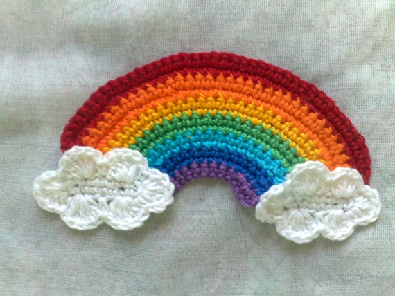Rainbow and clouds crocheted appliqués in white and in the rainbow colors violet, indigo, light blue, green, yellow, orange and red