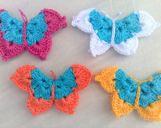 4 crocheted butterfly applications three-dimensional in a colorful mix for decorative embellishments to decorate baby clothes