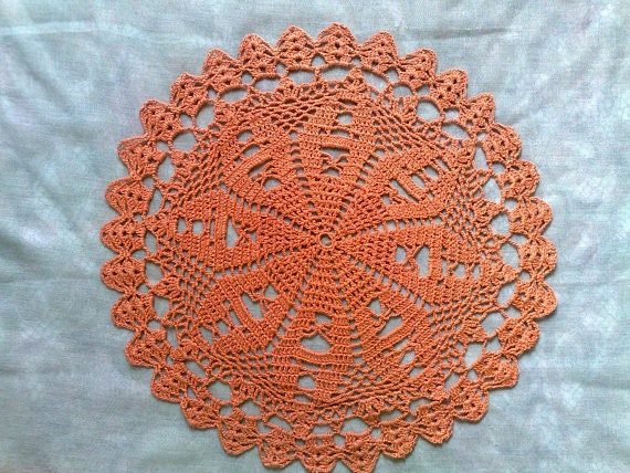 Crochet cover in orange hand crocheted jewellery for the coffee table