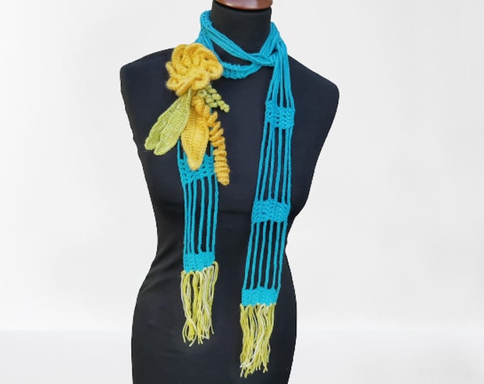 Crochet light blue lasso scarf with large yellow crochet flower and light green leaves and fringes, unique gift