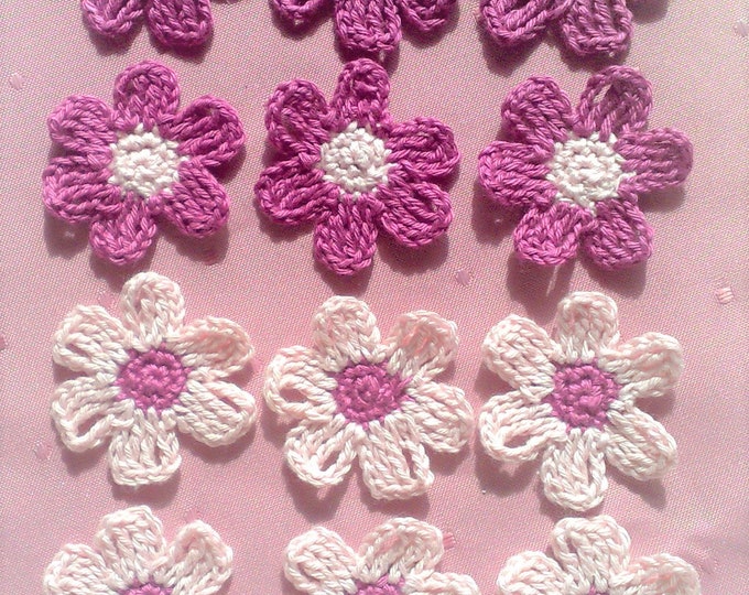 Small crocheted flowers in light pink and dark pink