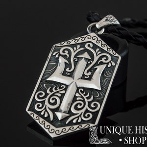 May include: Silver pendant necklace with a trident design. The pendant is detailed with intricate floral patterns and a black leather cord.