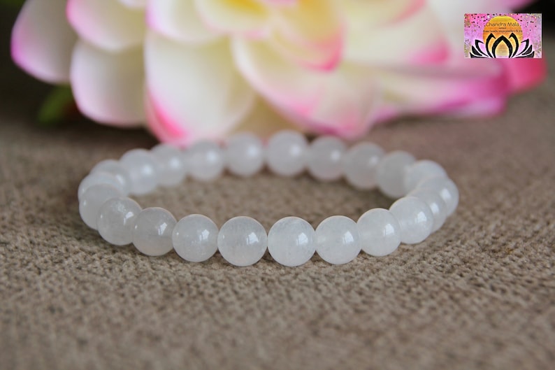 May include: White gemstone bracelet with round beads. The bracelet is made of natural white stones and is a simple and elegant piece of jewelry.