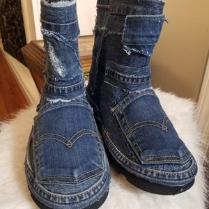 May include: A pair of blue denim boots made from repurposed denim fabric. The boots have a distressed look and are made with different shades of blue denim.