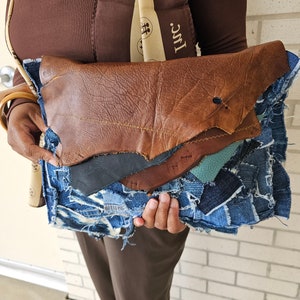 Custom denim patchwork & layered leather clutch