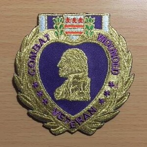 May include: Purple heart patch with gold embroidered laurel wreath and the words "Combat Wounded Veteran".
