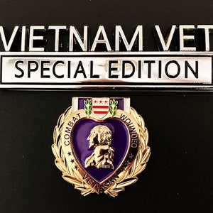 May include: A silver metal plaque with the text "Vietnam Vet Special Edition". Below the plaque is a gold-colored Purple Heart medal with a purple heart and a laurel wreath.