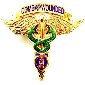 May include: A gold-colored pin with the text "COMBAT WOUNDED" on a banner. The pin features a caduceus design with two green snakes, wings, and a purple heart-shaped emblem.
