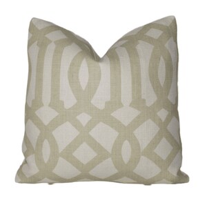 May include: A beige throw pillow with a geometric pattern in a lighter shade of beige.