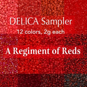 May include: A Delica sampler set featuring 12 colors of small cylindrical beads in various shades of red, ranging from light coral to deep burgundy. The text reads DELICA Sampler, 12 colors, 2g each, and A Regiment of Reds, displayed over the beads.