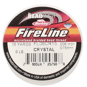 May include: A round spool of The Beadsmith Berkley FireLine microfused braided bead thread in Crystal color. The label specifies 15 yards, 6 lb test, and .006 inch diameter. It features a barcode, product code FL06CR15, and company website text.
