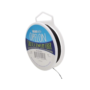 May include: A spool of black stretch jewelry fiber, labeled "Beadsmith Opelon Stretch Jewelry Fiber". The spool is 5 meters (16.4 feet) long and 1 mm (0.039 inches) thick.