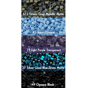May include: Assortment of seed beads in various colors and finishes, including green-grey metallic matte, aqua opaque, light purple transparent, silver-lined blue zircon matte, and opaque black.