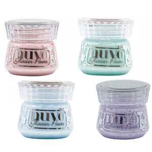 May include: Four jars of Nuvo Glacier Paste in four different colors: pink, teal, light blue, and lavender. Each jar has a clear lid with a decorative pattern.