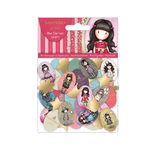 May include: A package of Santoro Gorjuss mini die-cuts, featuring illustrations of girls in various outfits. The package includes 140 pieces in various shapes and colors, with text that reads "Mini Die-cuts".