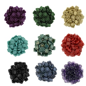 May include: Assortment of 10 small square ceramic tiles in various colors, including purple, green, gold, red, teal, black, and blue. Each tile has four small holes in the center.